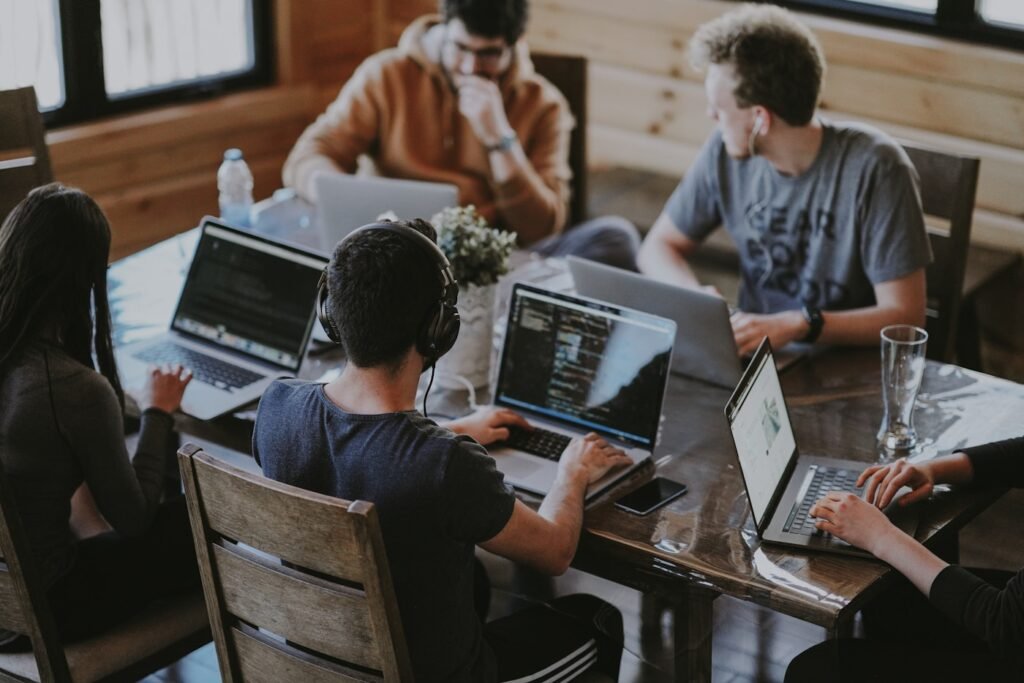 A small accounting team collaborating at a meeting table in a modern office.